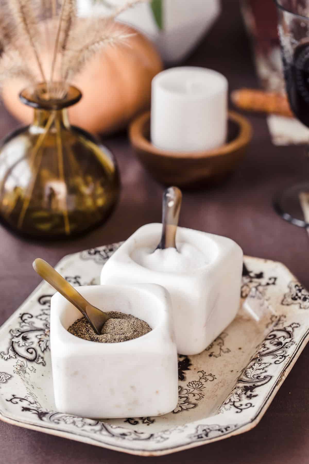 white marble salt and pepper dishes with tiny spoons