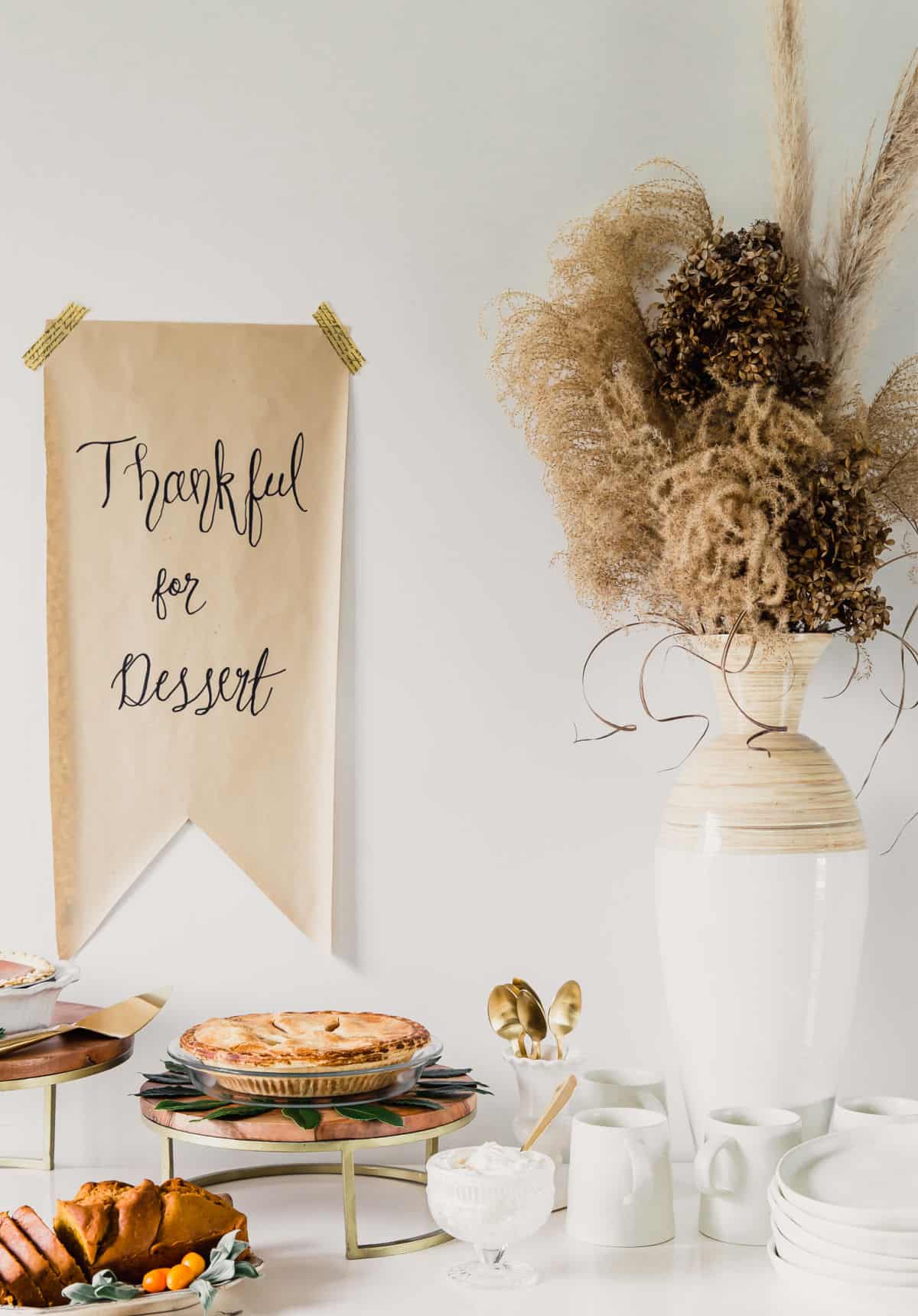 white table with pies and dried flower centerpiece