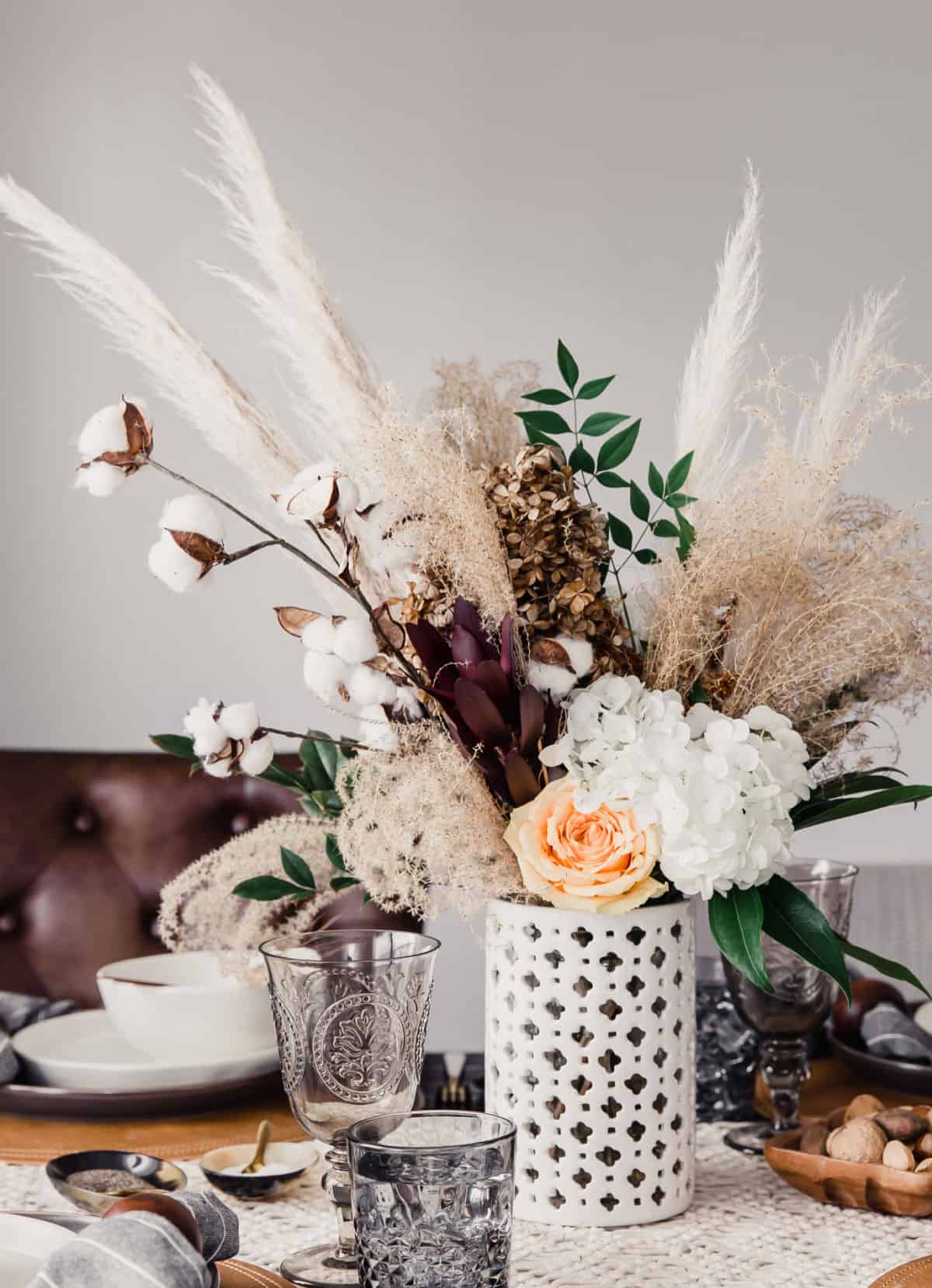 centerpiece with pampas grass and fresh flowers in white vase