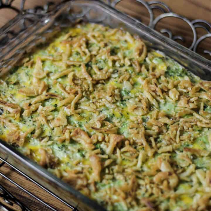 baked broccoli casserole in glass dish.