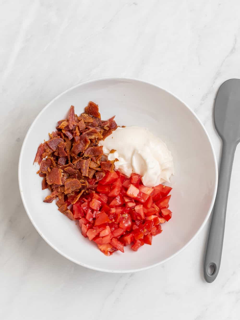 chopped tomato, bacon, and mayonnaise in white bowl.