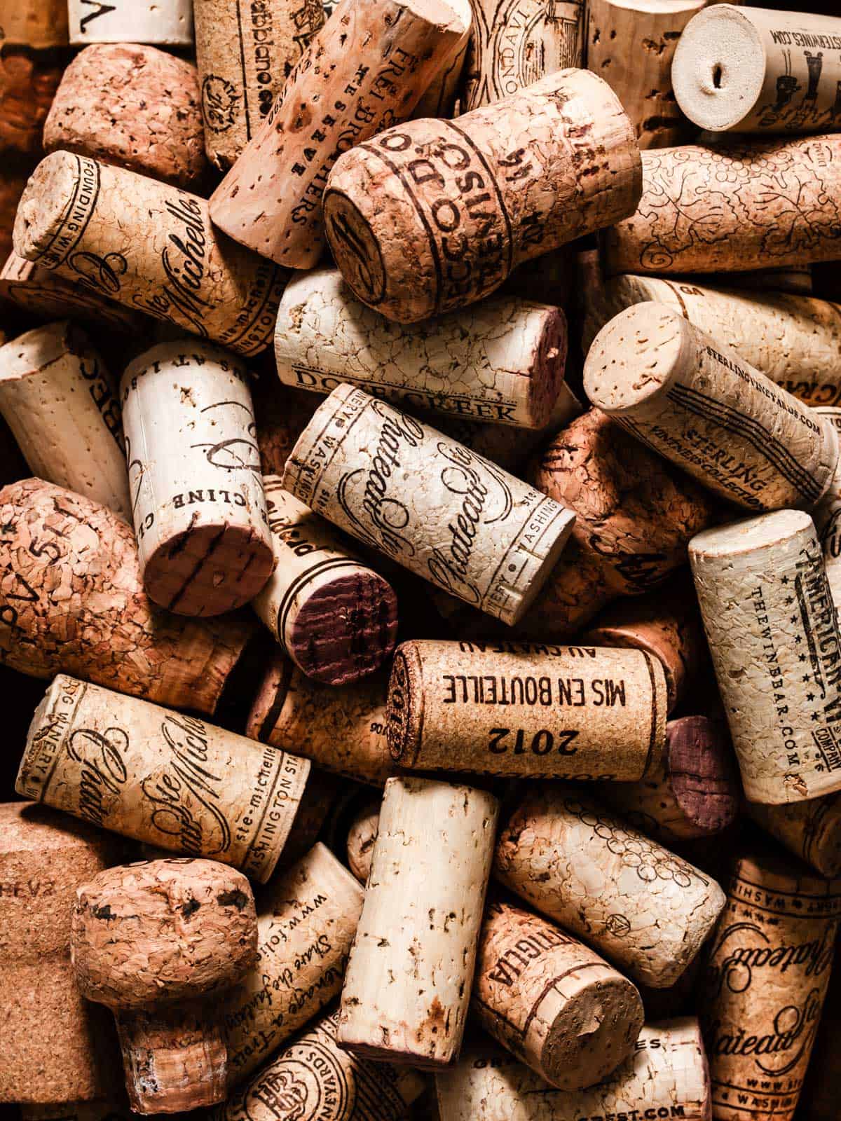 a collection of wine corks in a pile.