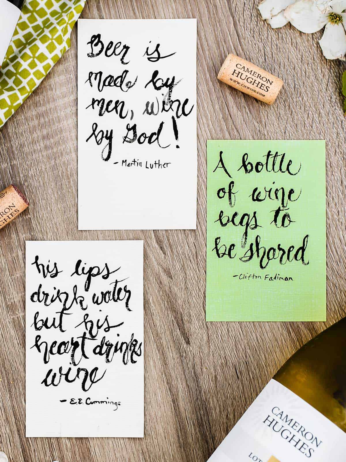 cards laying flat, with famous quotes about wine written on them.