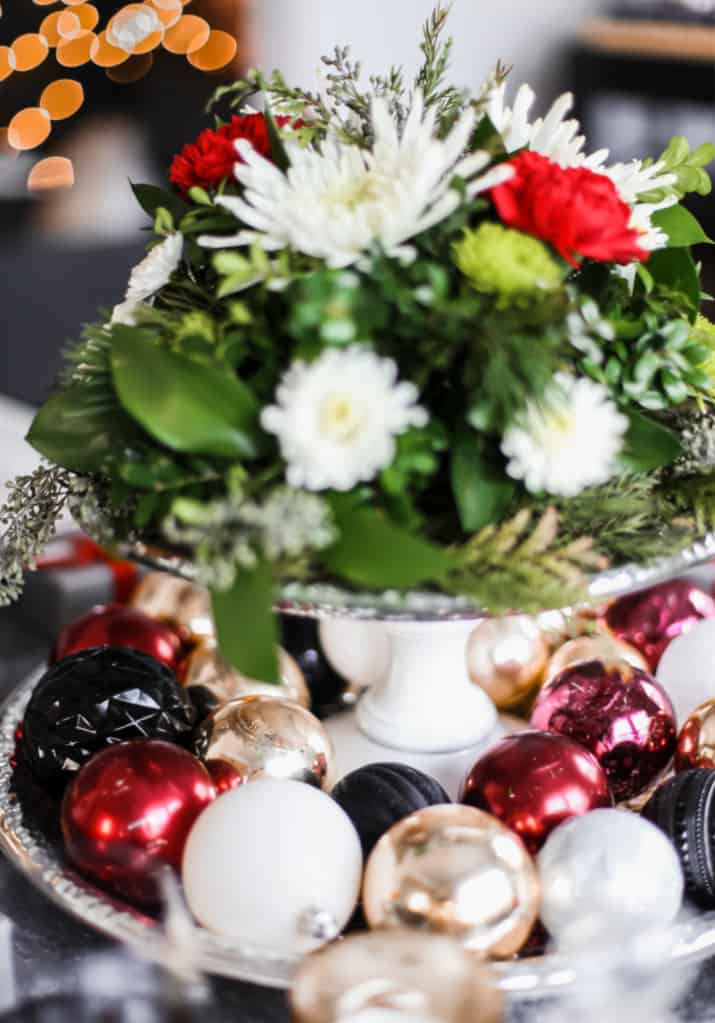 cake stand centerpiece for Christmas, with ornaments and flowers