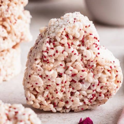 heart shaped cutout rice krispie treat with red cranberry seeds