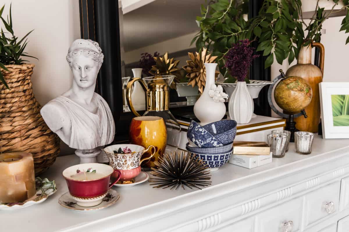 white table filled with home decor items for a swap party.