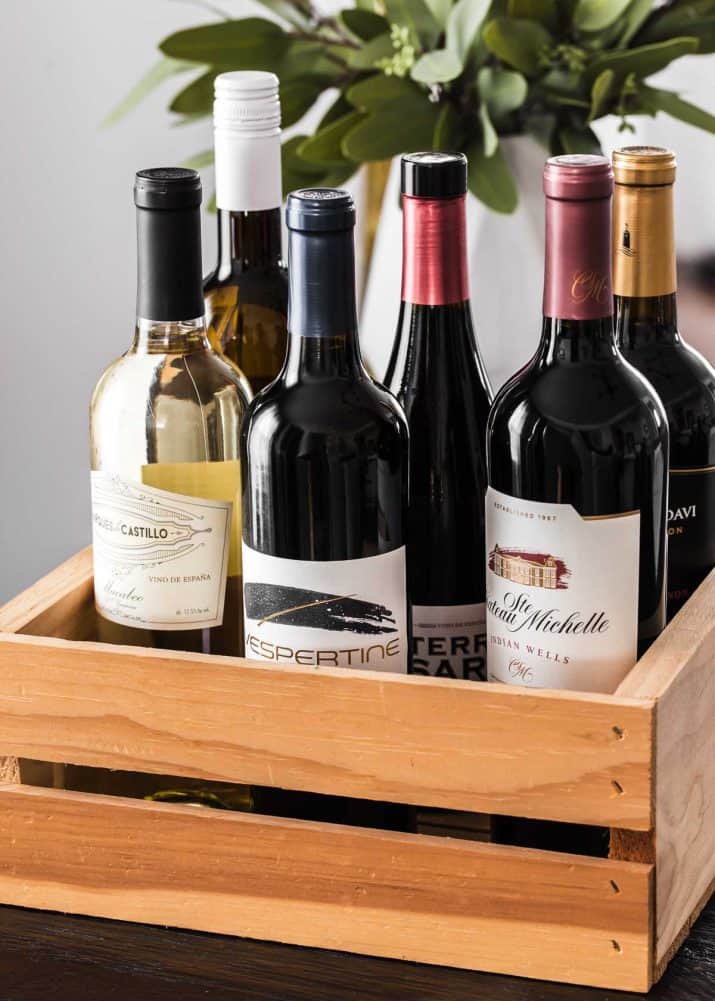 bottles of wine displayed inside wood crate.