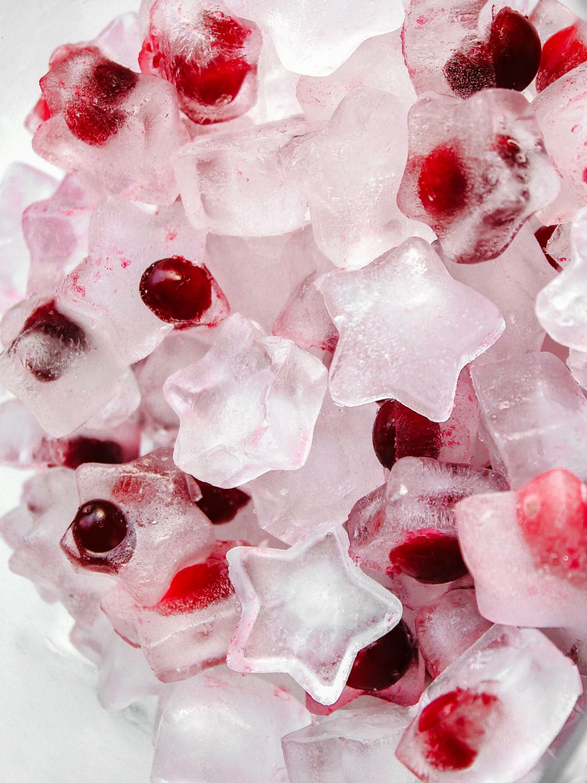 star shaped ice cubes with cranberries frozen inside.