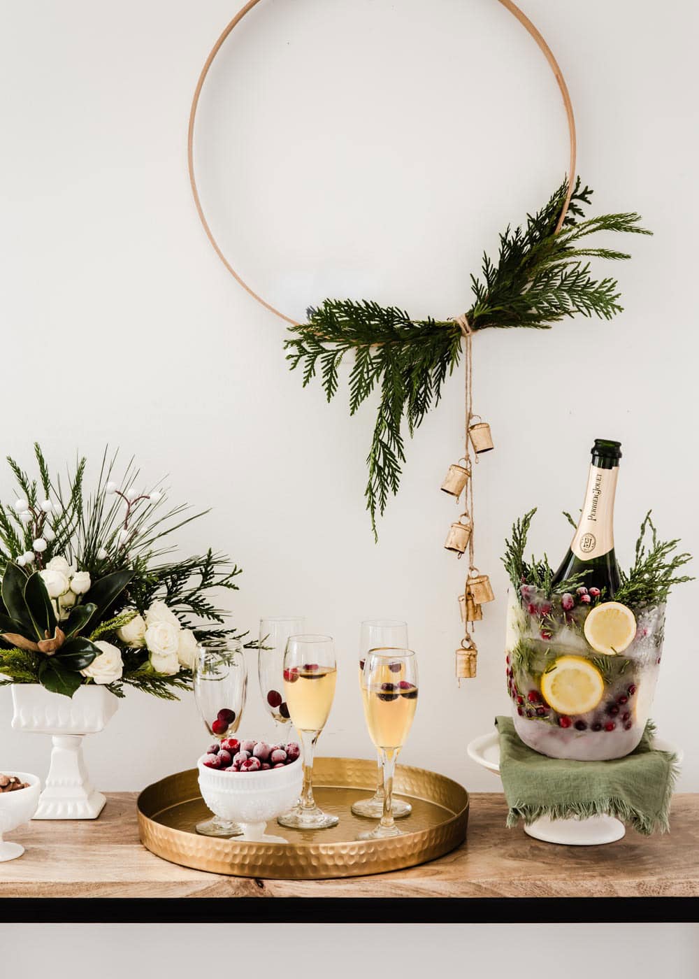 holiday champagne bar with ice mold and glasses on tray.