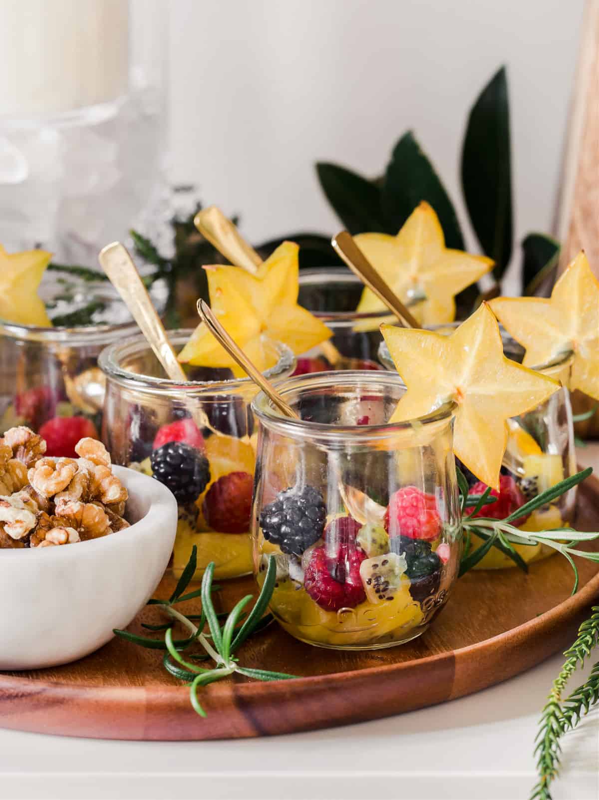 fresh fruit in mini jars with star fruit garnish on rim