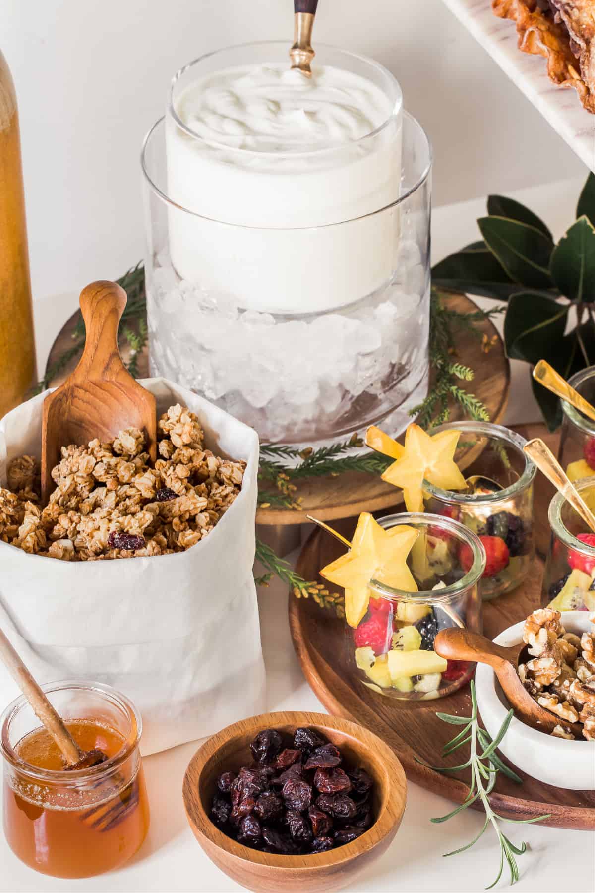 mini granola bar with toppings, and yogurt, and mini jars of fruit.