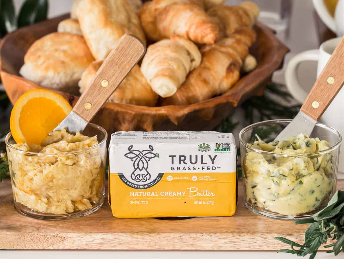 package of Truly Grass Fed butter with two flavored butters in glass dishes