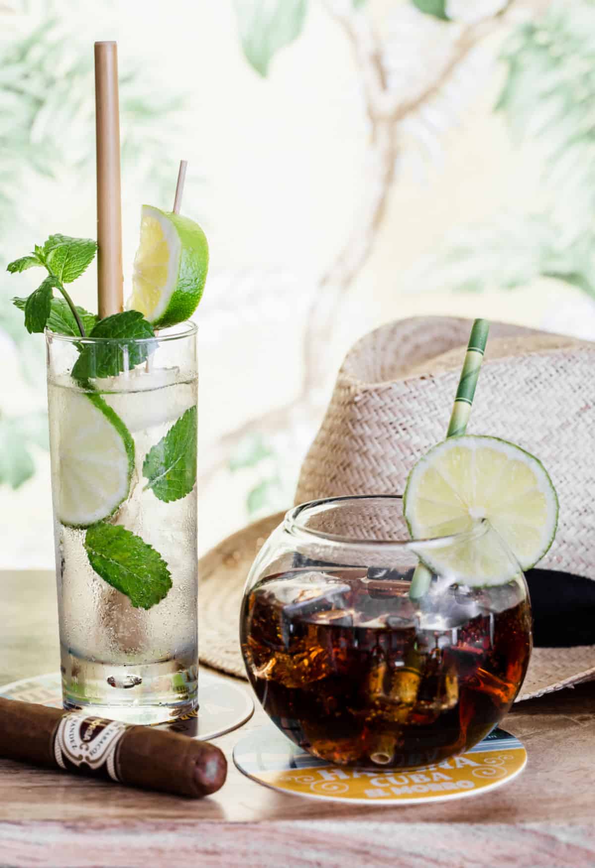 mojito and rum and coke drinks on wood table.