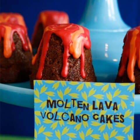 mini lava cakes on blue cake stand with label card attached.