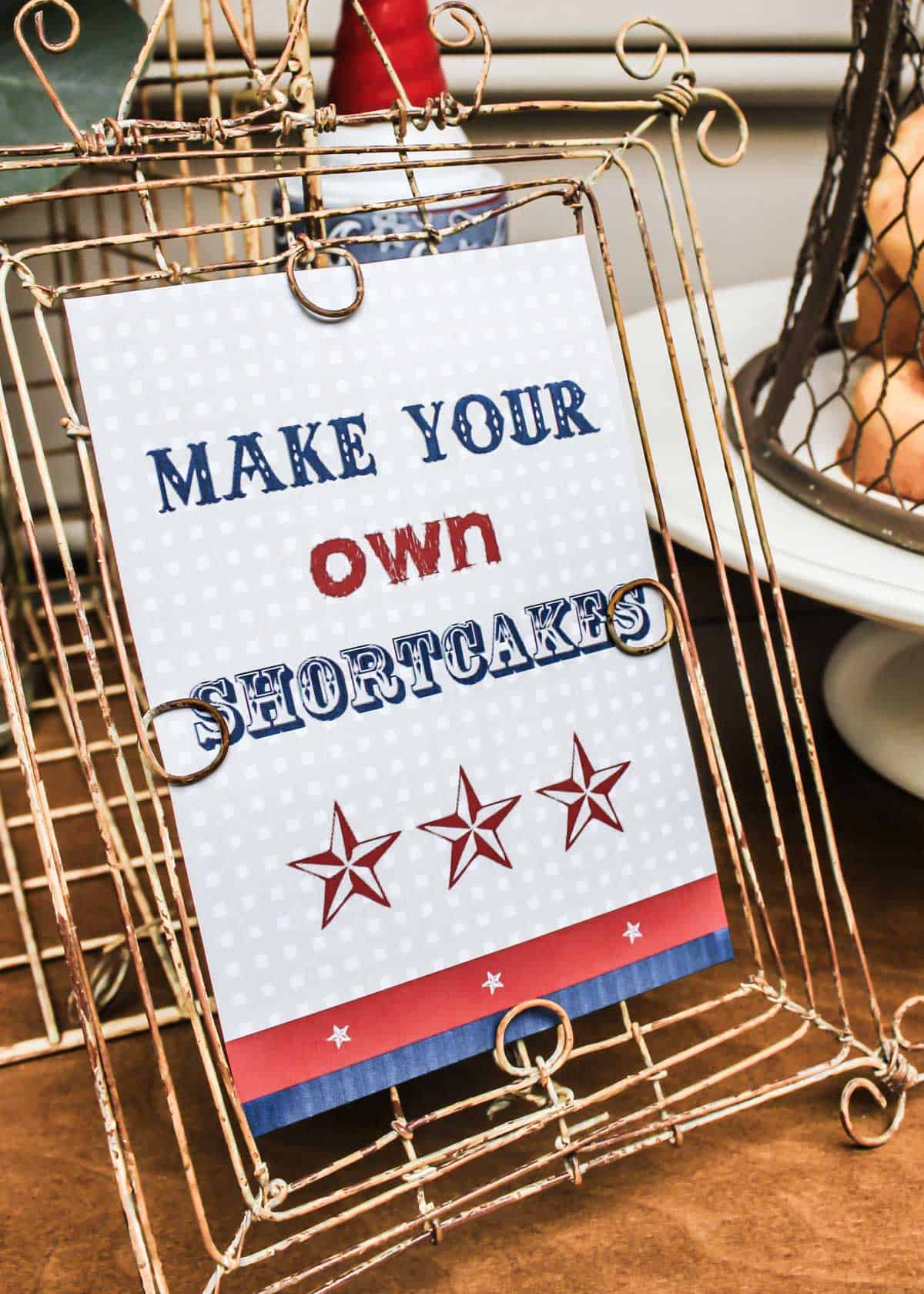 printed sign to "make your own shortcakes" placed in wire frame.