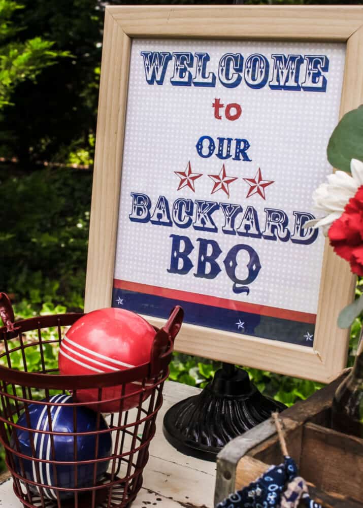 red, white and blue printed backyard bbq sign in frame.