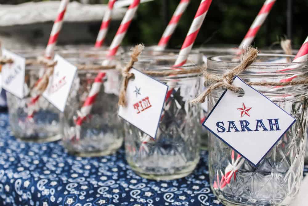 jars for drinks with straws and name tags tied on.