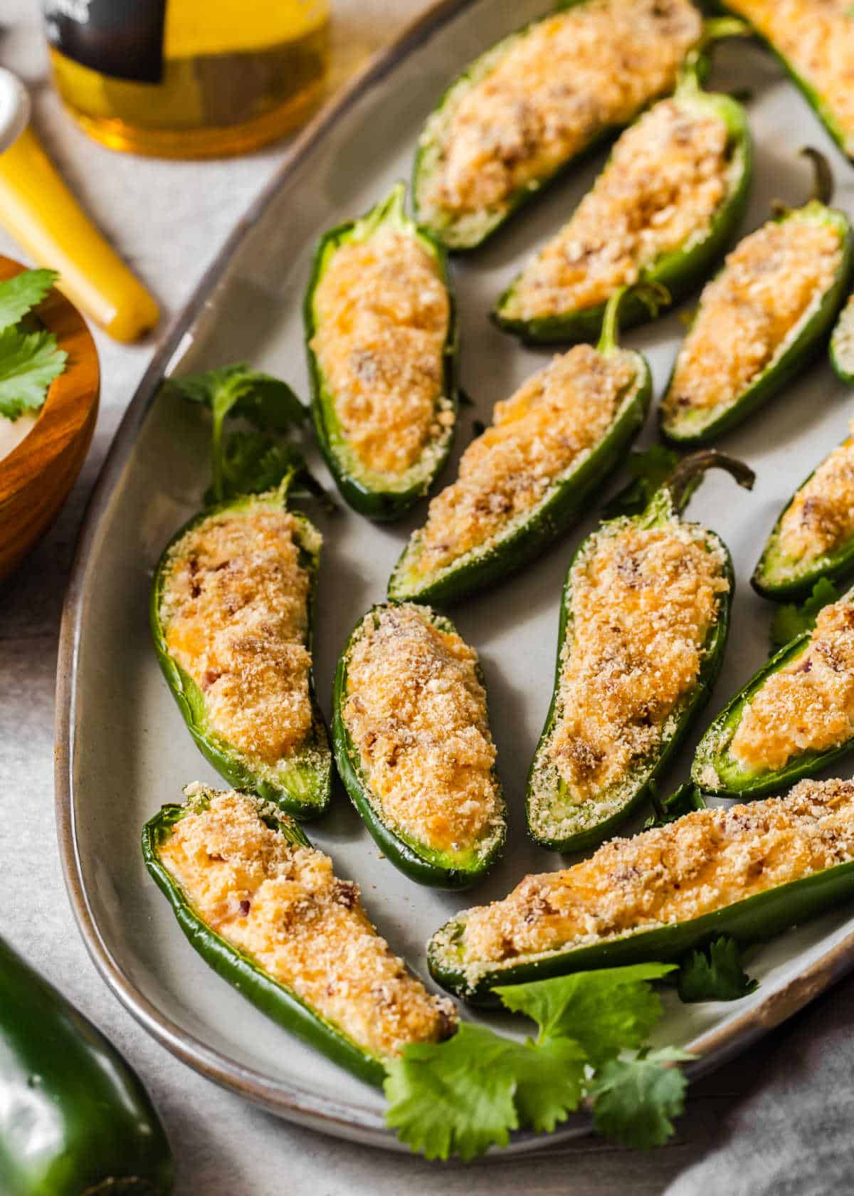 platter filled with baked jalapeno peppers.