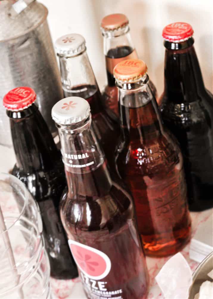 soda bottles clustered together on party table.