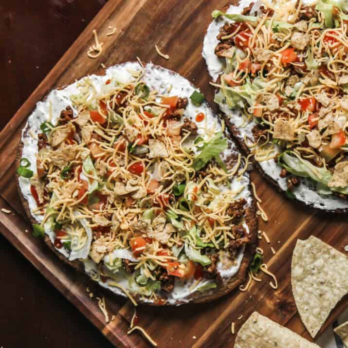Mexican pizza twist with fresh toppings and crumbled tortilla chips.