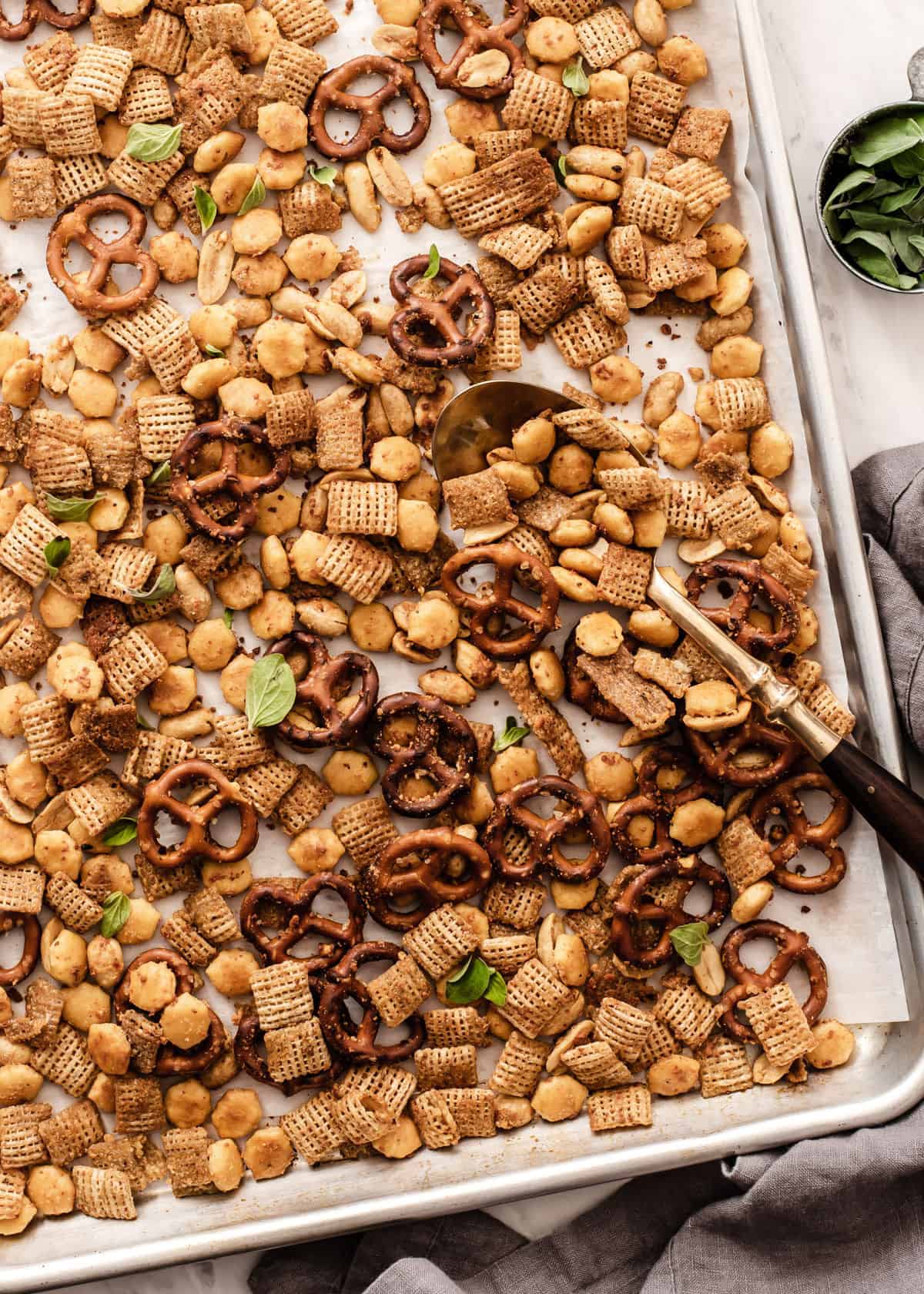 sheet pan with baked Chex mix and spoon to scoop it up.