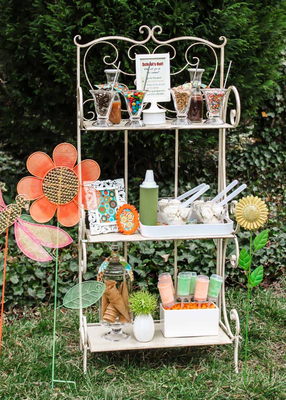 garden shelf outside set up with DIY ice cream sundae fixings.