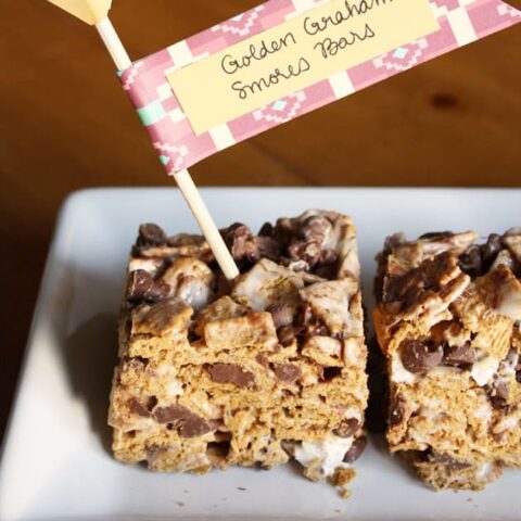 s'mores bars make with Golden Grahams, on white dish.