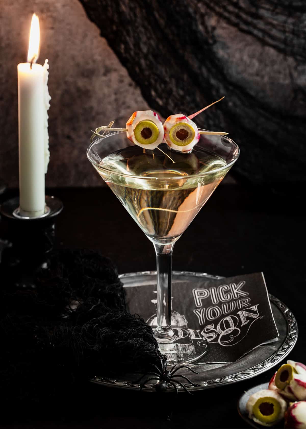 dirty martini garnished for Halloween with radish eyeballs.