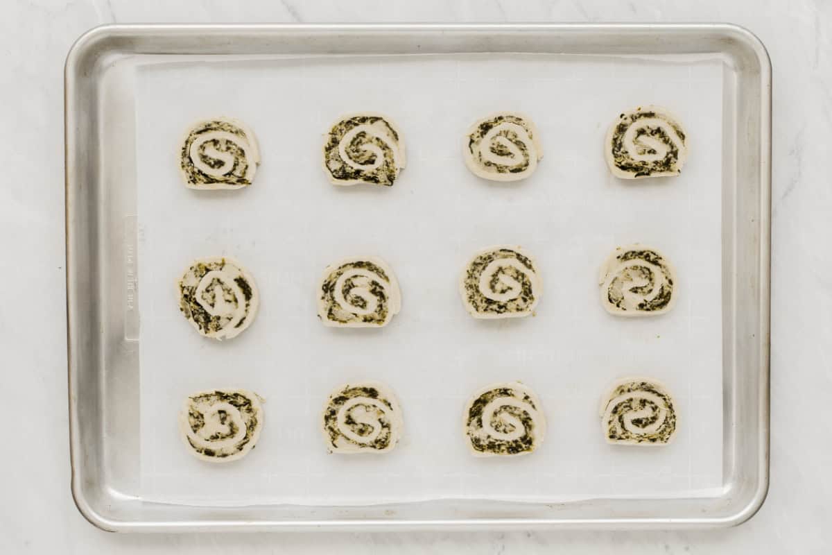 puff pastry pinwheels cut and ready to bake, on sheet pan.