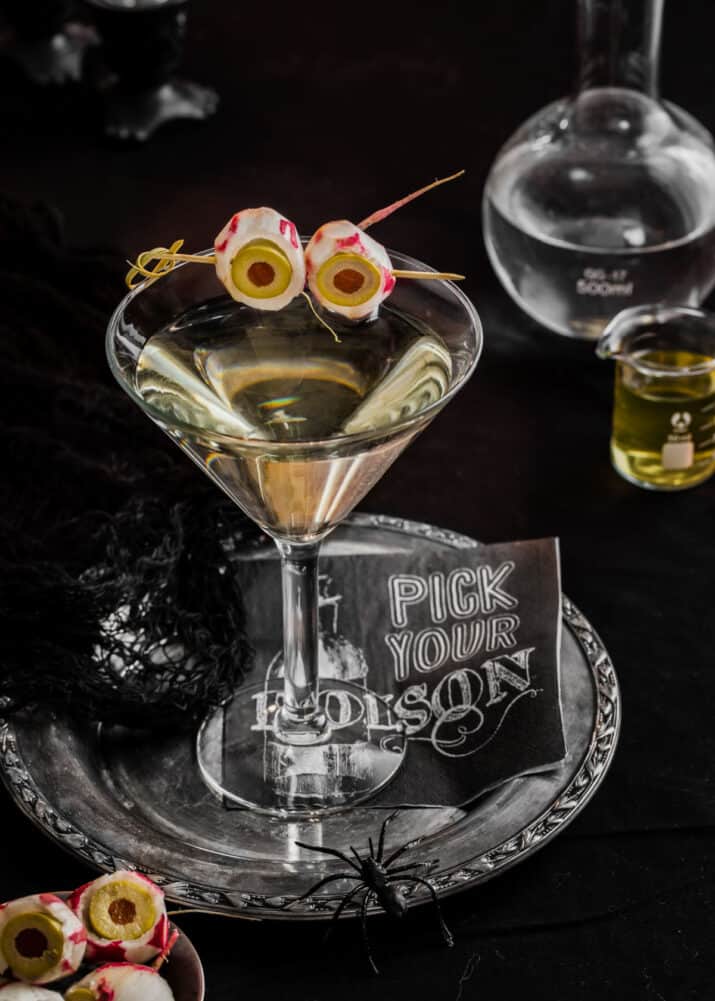 dirty martini garnished for Halloween with radish eyeballs.