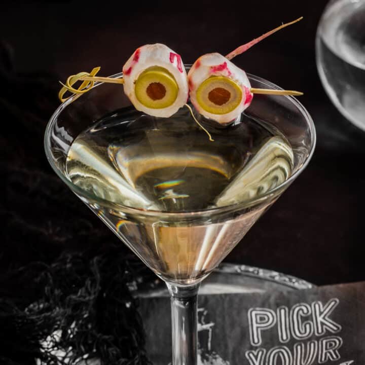 dirty martini garnished for Halloween with radish eyeballs.