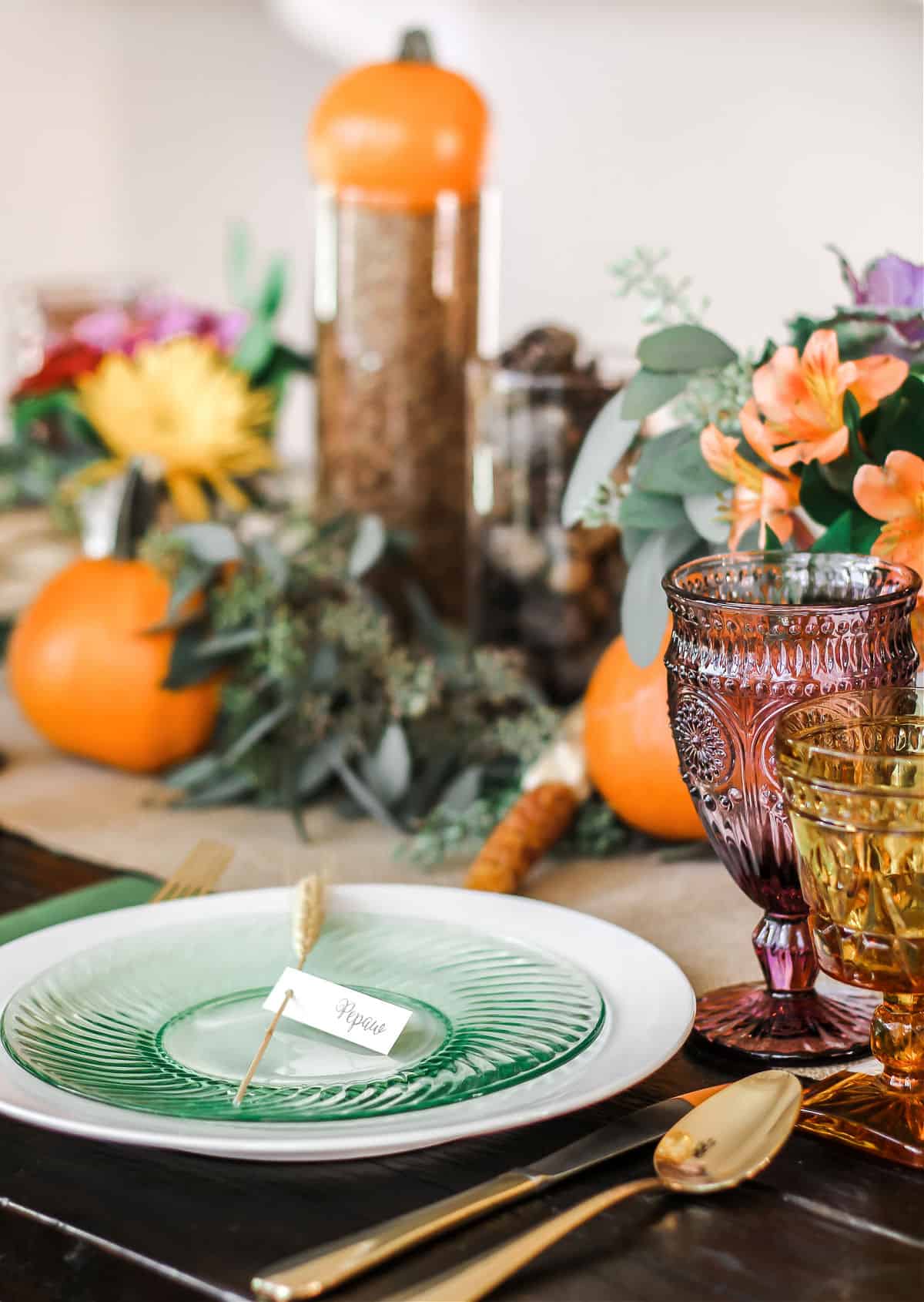 place setting on dining table with green plate on white plate