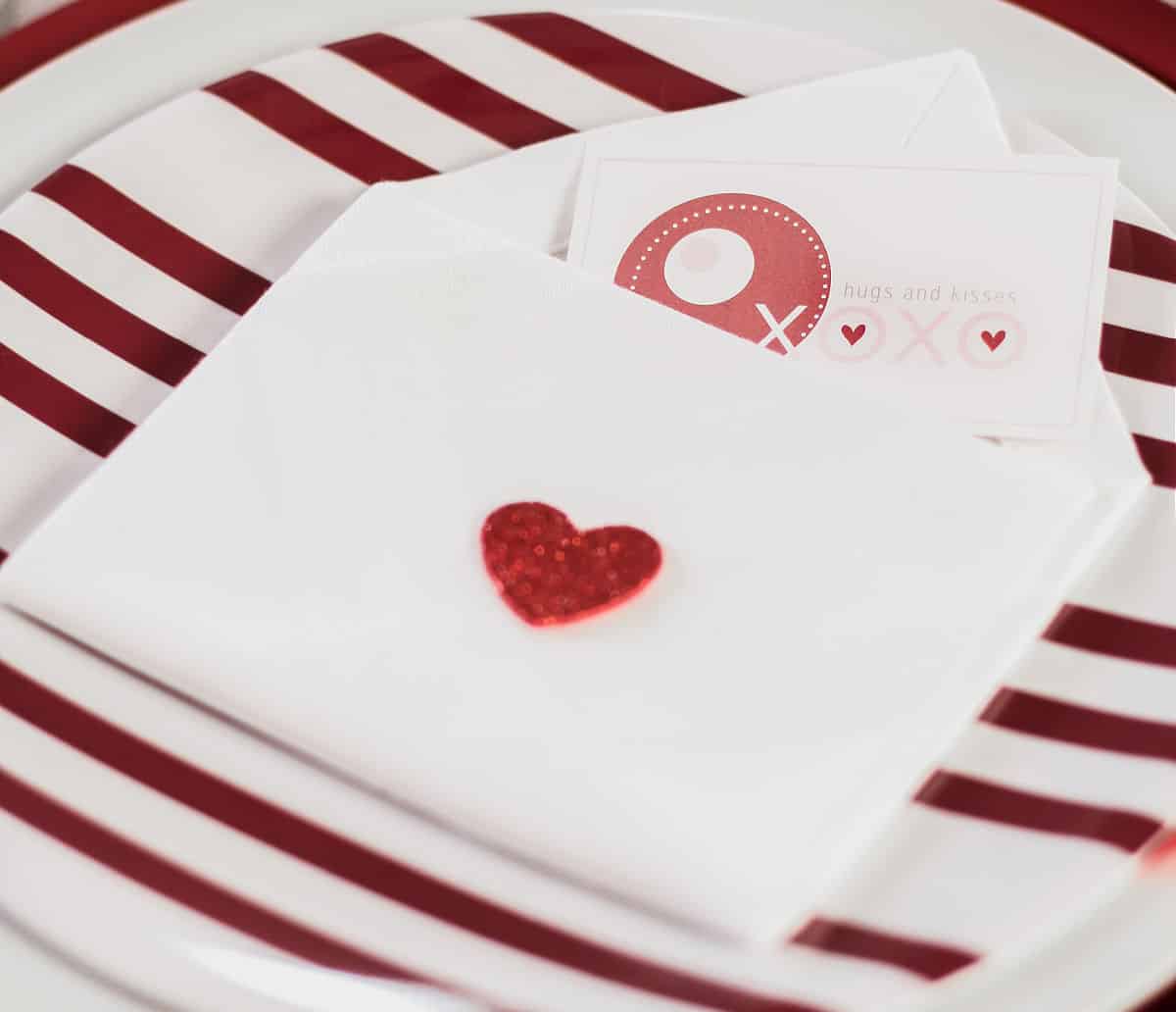 white napkin folded into envelope form with card tucked inside.