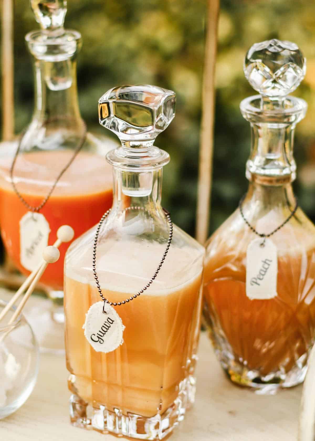 traditional liquor decanters filled with different juices.