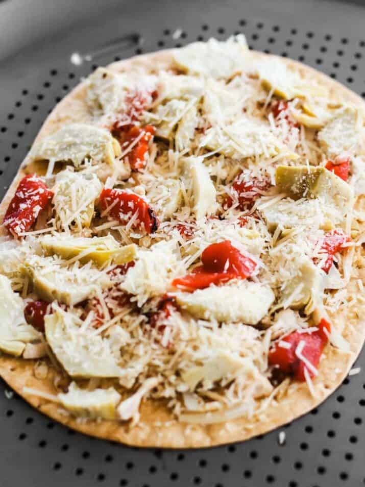 thin crust pizza with toppings ready to go in oven.