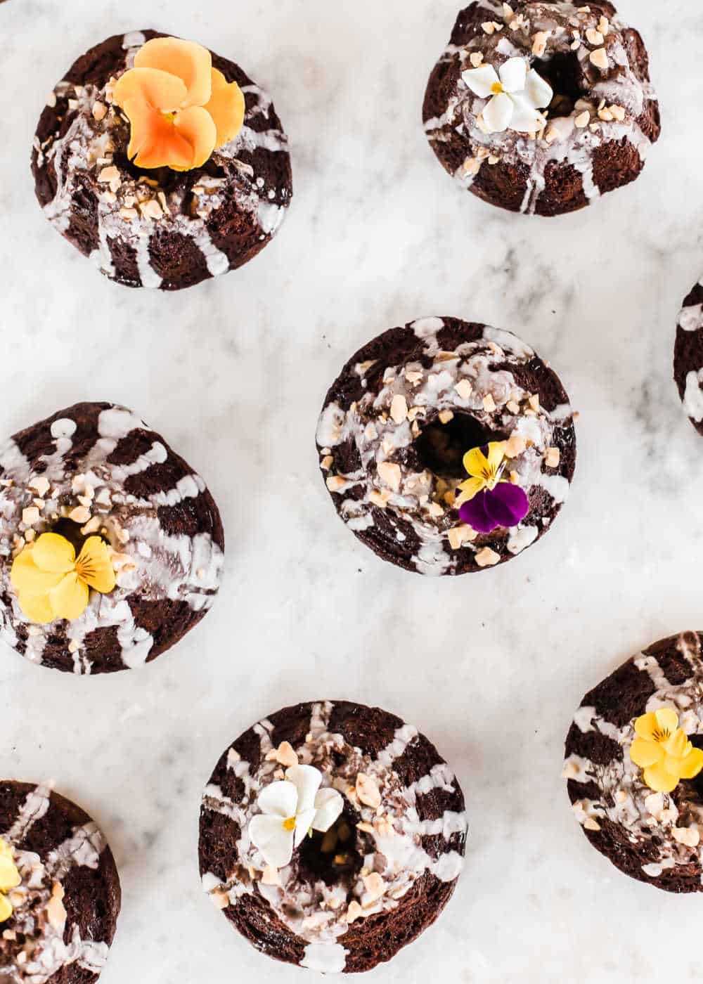 mini chocolate cakes on white table, overhead.