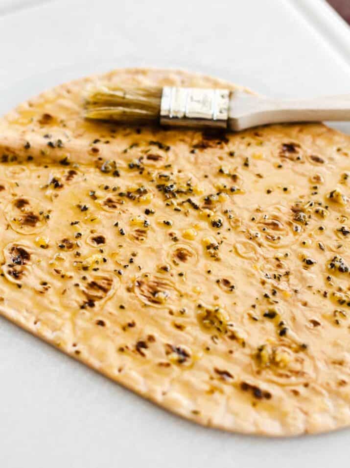 flat pizza crust brushed with seasoned olive oil.