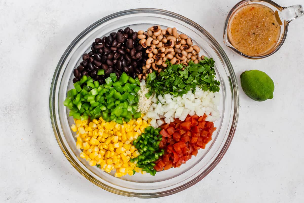 cowboy salsa ingredients in glass bowl, overhead.