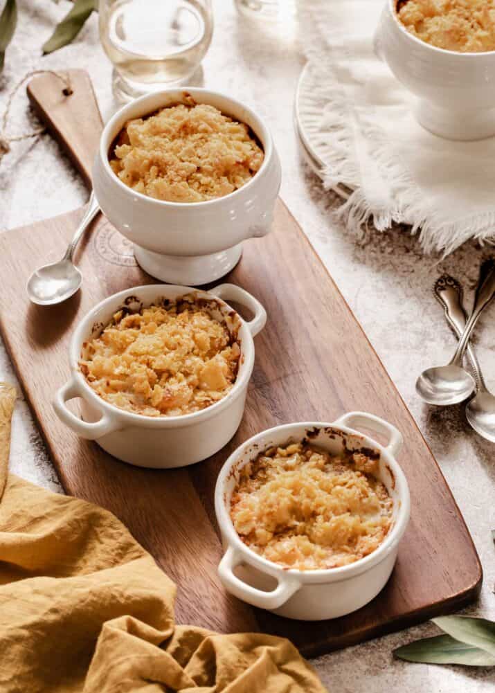 macaroni and cheese in 3 individual white baking dishes, topped with crushed crackers.