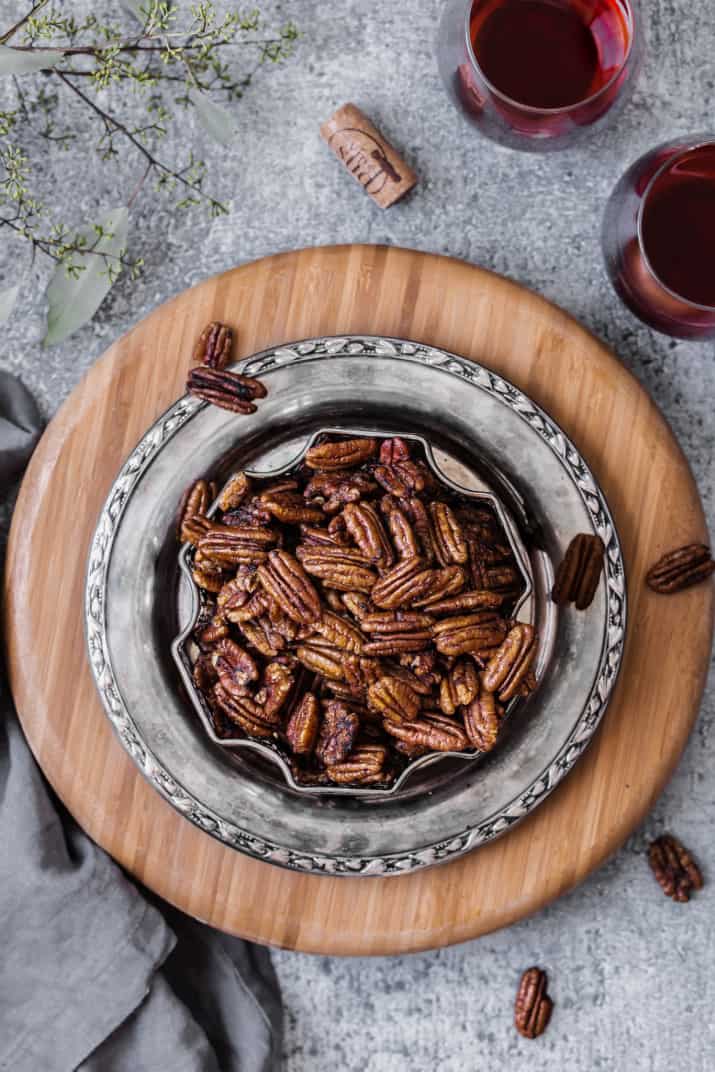savory spicy pecans in silver plate overhead view