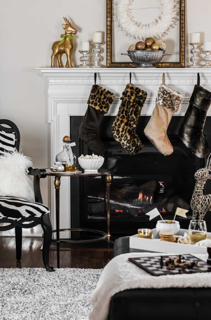 animal print Christmas stockings on mantel in neutral living room