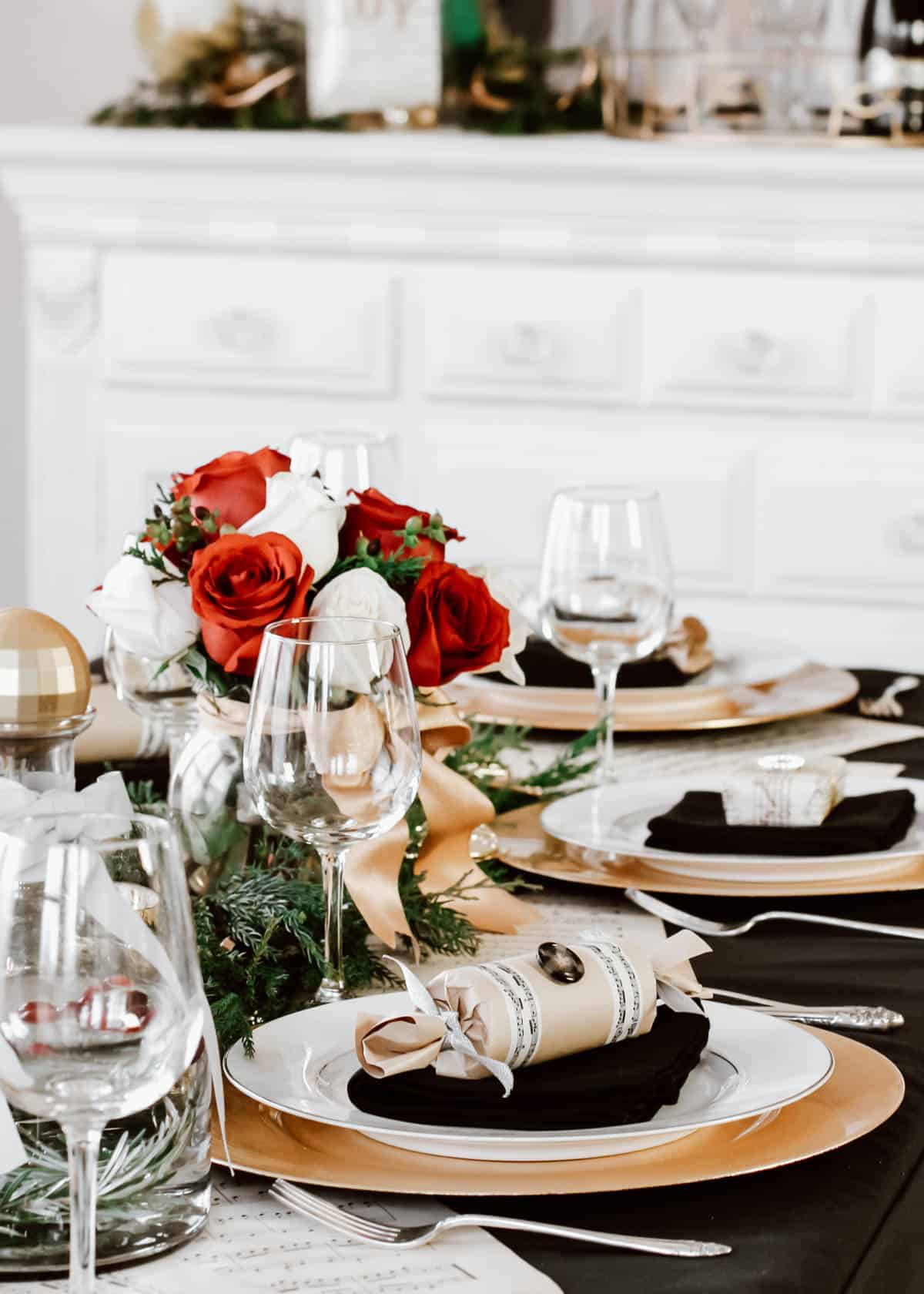 Christmas tablescape with red and white roses centerpiece and sheet music details.