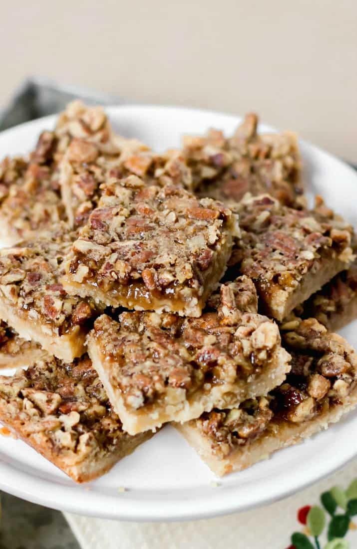 easy pecan pie bars with sugar cookie crust on white dish