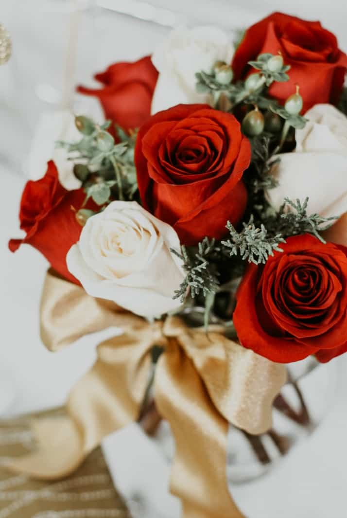 red and white roses in glass vase