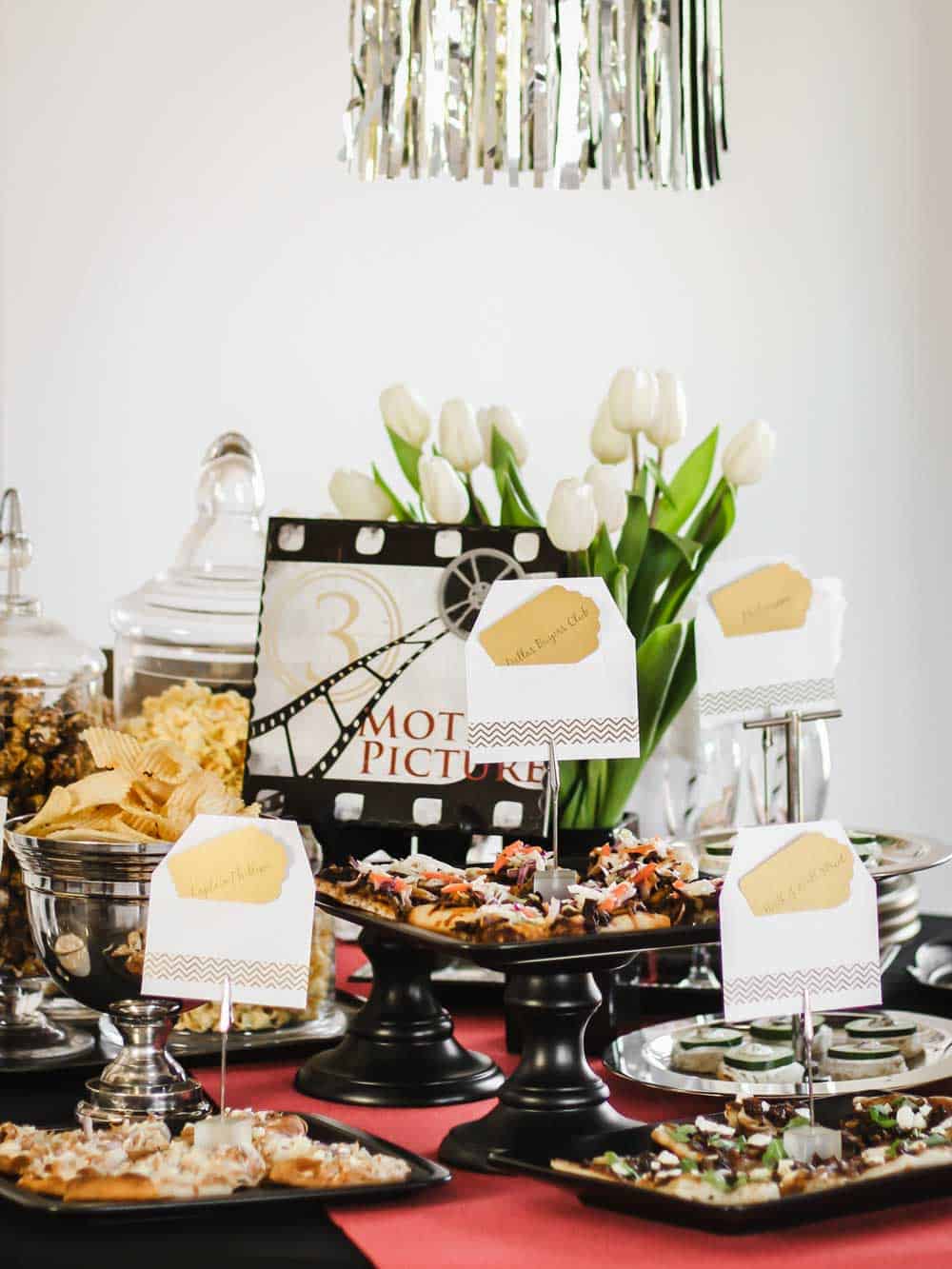 party buffet table with several pizzas, and snacks.