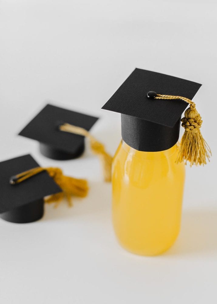 small milk bottles topped with DIY graduation caps.