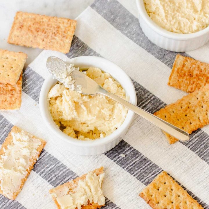 ramekin filled with beer cheese spread surrounded by club crackers.