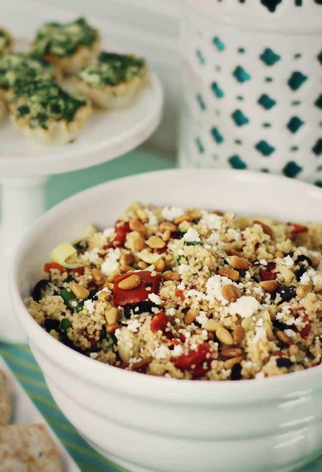This Greek style couscous makes a terrific and easy side dish for potluck parties or entertaining guests. This Greek-Style Couscous Recipe gives any meal some International flavor. This makes a terrific side dish for a Greek themed dinner party, or a potluck party. You can even turn it into a one dish meal! #sidedishrecipe #couscous #GreekFood