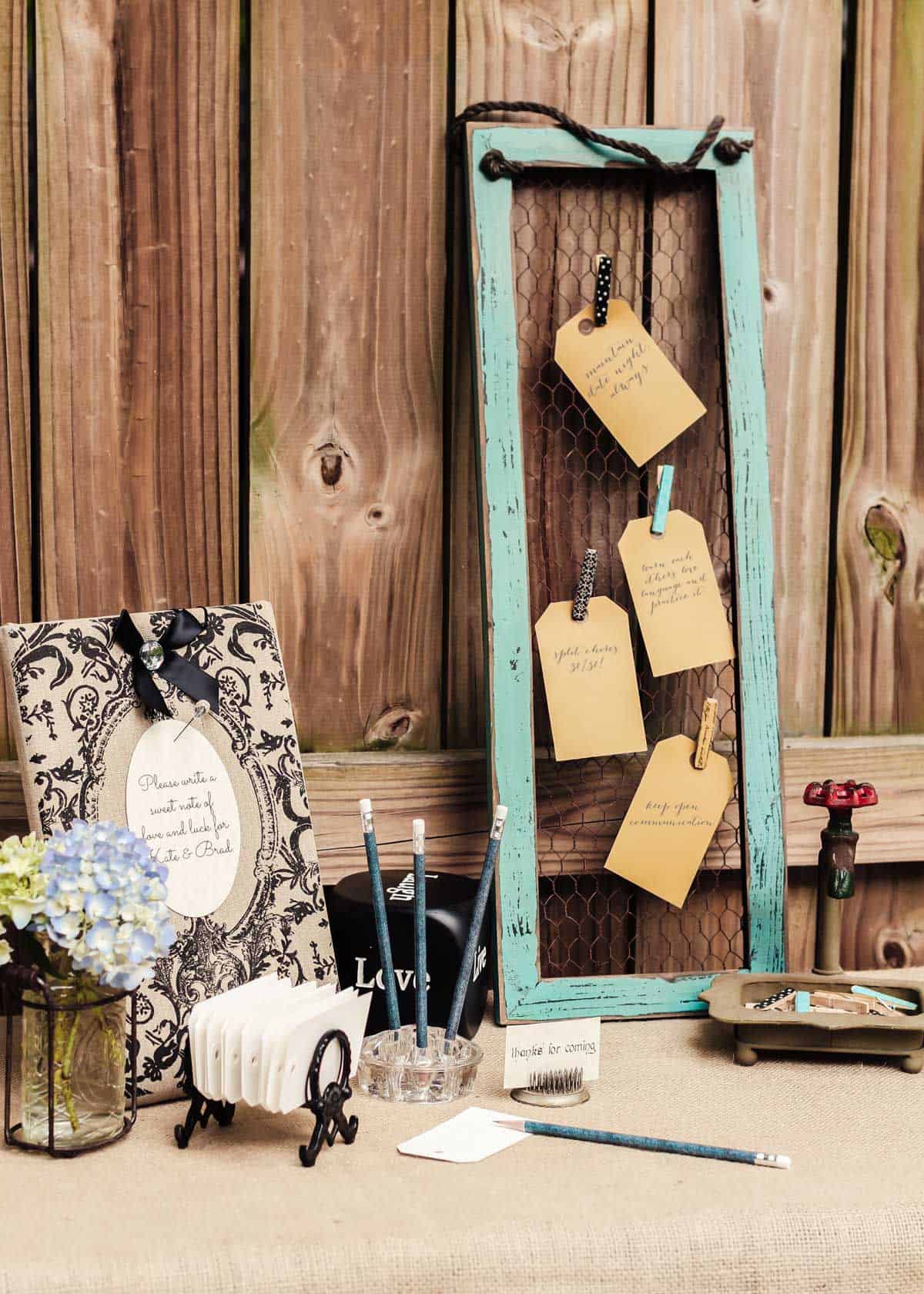bridal shower note cards table set up outside, with vintage decorations.