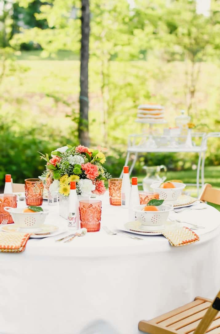 ideas to host a garden party with orange and white table setting outside